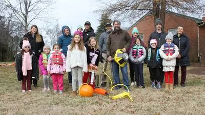 Dr Andrew Thaler with the St Michaels Girl Scouts prior to deployment of Smart buoy into the lagoon by Honeymoon Bridge seen lying on ground in picture