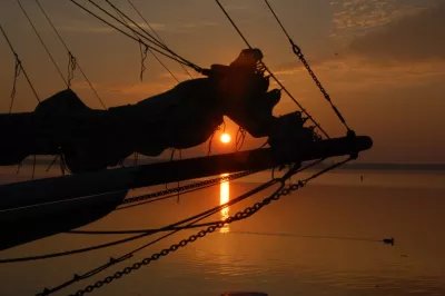Silhouette of bow of boat at sunset