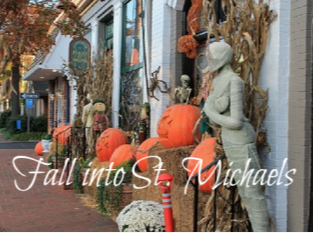 photo of downtown st michaels decorated for fall with pumpkins, cornstalks, and scarecrows